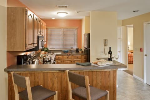 Deluxe Suite, 2 Bedrooms | Private kitchen | Full-size fridge, microwave, stovetop, coffee/tea maker