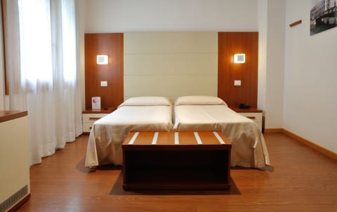 Twin Room | Minibar, in-room safe, desk, soundproofing