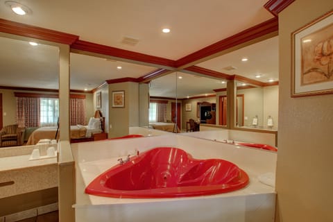 Suite, 1 King Bed, Jetted Tub | Bathroom | Combined shower/tub, free toiletries, hair dryer, towels