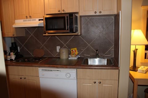 Suite, 1 Queen Bed | Private kitchen | Full-size fridge, microwave, stovetop, dishwasher