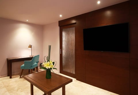 Suite, 1 King Bed with Sofa bed | Living area | 55-inch LCD TV with satellite channels, TV