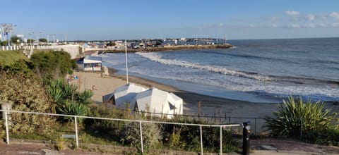 On the beach, white sand, sun loungers, beach umbrellas