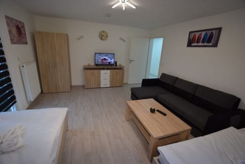 Apartment, 3 Bedrooms (23-00) | Living room | Flat-screen TV