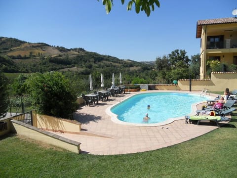Outdoor pool, open 8 AM to 7 PM, pool umbrellas, sun loungers