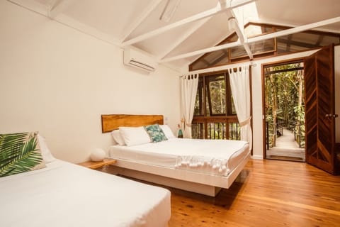 Twin/Tripe Rainforest Cabin | Minibar, individually decorated, individually furnished