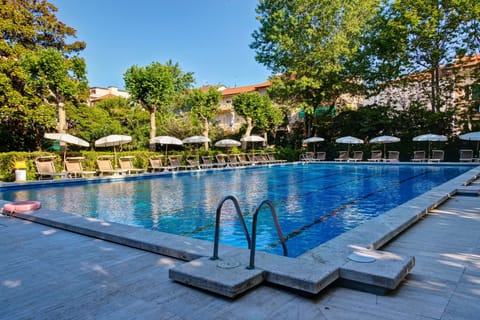 Seasonal outdoor pool, open 9:00 AM to 7:00 PM, pool umbrellas