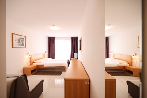 Standard Double Room, Partial Sea View | Pillowtop beds, in-room safe, desk, laptop workspace