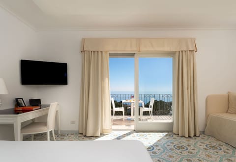 Triple Room, Sea View | Minibar, in-room safe, desk, laptop workspace