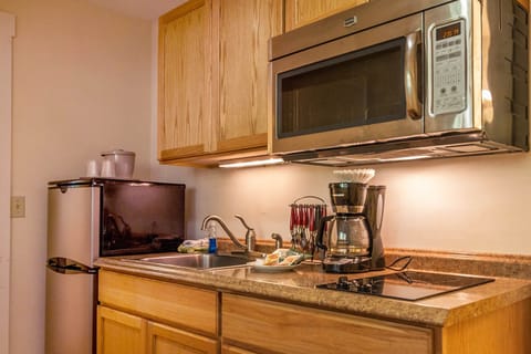 Triple Queen Suite | Private kitchen | Fridge, coffee/tea maker