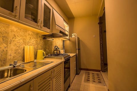 3-Bedroom Apartment | Private kitchen | Full-size fridge, microwave, stovetop, cookware/dishes/utensils