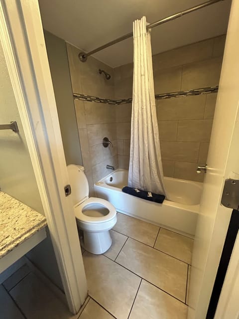 Economy Room, 2 Queen Beds | Bathroom | Shower, free toiletries, hair dryer, towels