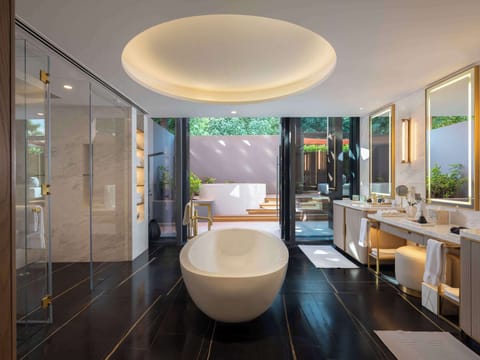 Separate tub and shower, designer toiletries, hair dryer, bathrobes