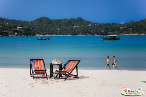 On the beach, white sand, beach umbrellas, beach towels