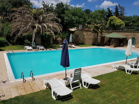 Outdoor pool, open 9 AM to 8 PM, pool umbrellas, sun loungers
