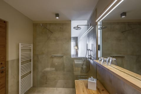 Shower, designer toiletries, hair dryer, bathrobes