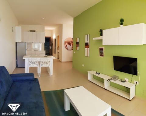 Family Double Room, Partial Sea View | Living area | 32-inch flat-screen TV with satellite channels, TV