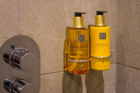 Combined shower/tub, bathrobes, slippers, towels