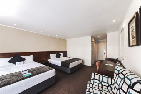 Premium bedding, desk, laptop workspace, blackout drapes