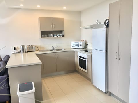 Apartment 04 Two bedroom, Two bathroom | Private kitchen | Full-size fridge, microwave, oven, stovetop