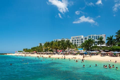 On the beach, white sand, beach umbrellas, beach towels