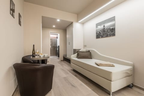 Deluxe Quadruple Room | Living area | Flat-screen TV