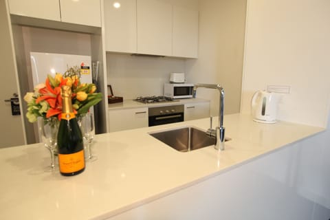 Deluxe One Bedroom Apartment | Private kitchen | Full-size fridge, microwave, oven, stovetop