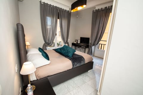 Deluxe Double Room | Desk, blackout drapes, iron/ironing board, cribs/infant beds