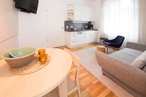 Deluxe Apartment, Ground Floor | Living area | Flat-screen TV, DVD player