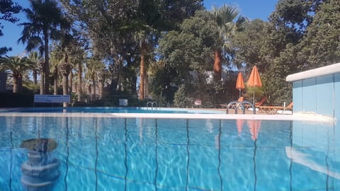 Seasonal outdoor pool, open 9:00 AM to 7:00 PM, pool umbrellas