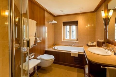 Separate tub and shower, designer toiletries, hair dryer, bathrobes