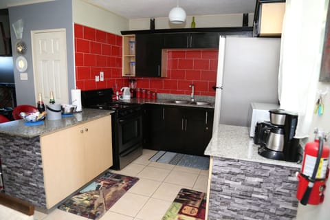 Oasis Townhouse Multiple Rooms, Beds | Private kitchen | Full-size fridge, microwave, oven, stovetop