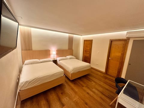 Quadruple Room | Minibar, in-room safe, individually decorated, individually furnished