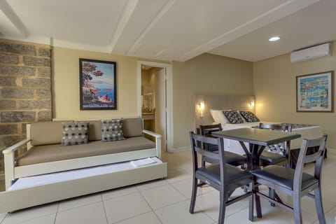 Family Room, Garden View | Blackout drapes, iron/ironing board, free WiFi, bed sheets