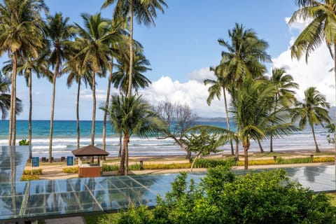 On the beach, white sand, sun loungers, beach towels