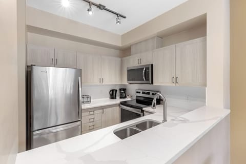 Condo, 2 Bedrooms (Unit 52) | Private kitchen | Full-size fridge, microwave, oven, stovetop