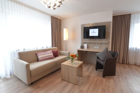 Deluxe Double Room | Living area | Flat-screen TV