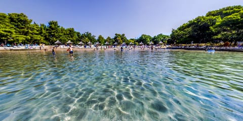 On the beach, white sand, free beach cabanas, sun loungers