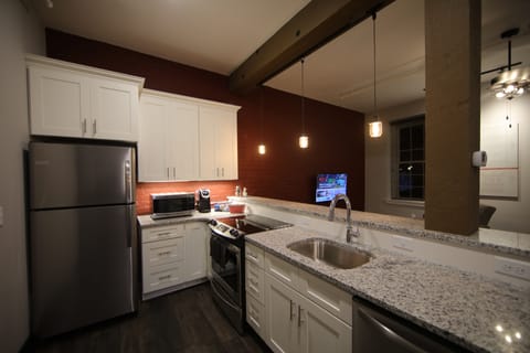 Signature Studio Suite, 1 King Bed, Non Smoking, City View | Private kitchen | Full-size fridge, microwave, oven, stovetop