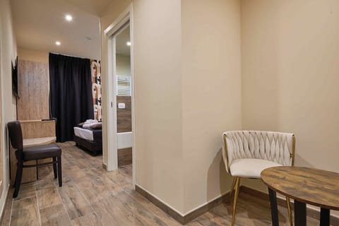 Deluxe Double Room 16 | Living area | 55-inch flat-screen TV with digital channels