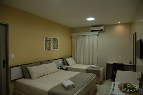 Deluxe Triple Room, Multiple Beds | Minibar, in-room safe, blackout drapes, free WiFi