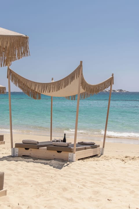 On the beach, white sand, sun loungers, beach umbrellas