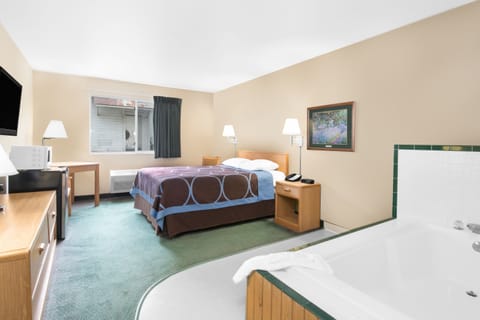 Suite, 1 Queen Bed, Jetted Tub | Desk, laptop workspace, blackout drapes, free WiFi