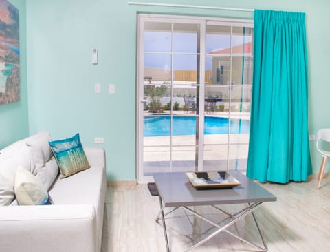 Deluxe Suite, 2 Bedrooms, Pool View | Living area | Smart TV