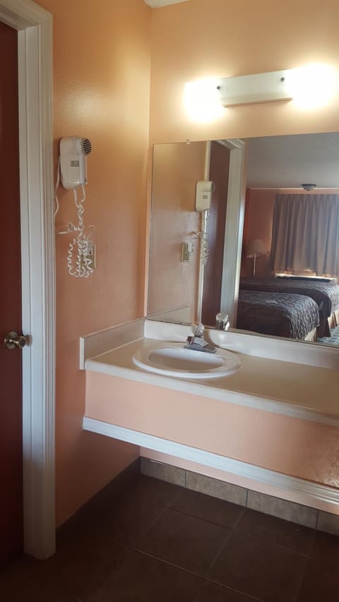 Bathtub, rainfall showerhead, hair dryer, towels