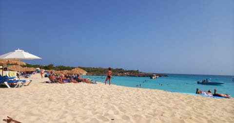 Beach nearby, white sand, sun loungers, beach umbrellas