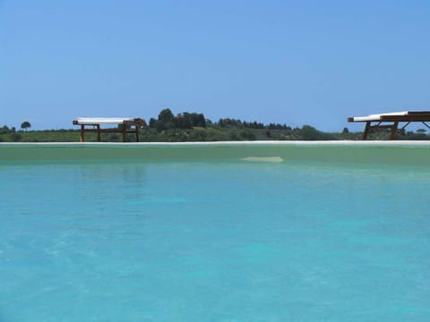 Seasonal outdoor pool, open 9:00 AM to 8:00 PM, pool umbrellas