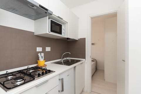 Apartment, Garden Area | Private kitchen | Full-size fridge, microwave, stovetop, coffee/tea maker