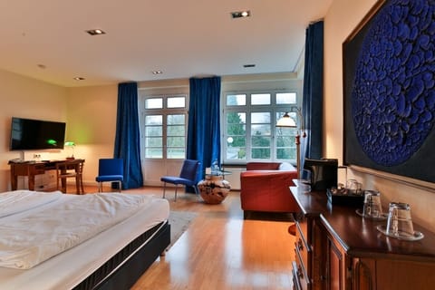 Junior Suite, Patio, Lake View | Living area | 27-inch flat-screen TV with satellite channels, TV