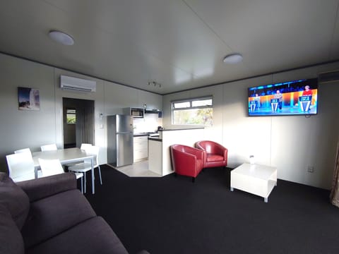 Deluxe Lodge | Living area | 30-inch TV with satellite channels