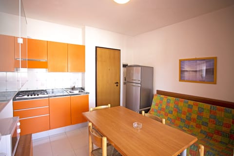 Comfort Condo, 2 Bedrooms | Private kitchen | Full-size fridge, microwave, stovetop, cookware/dishes/utensils